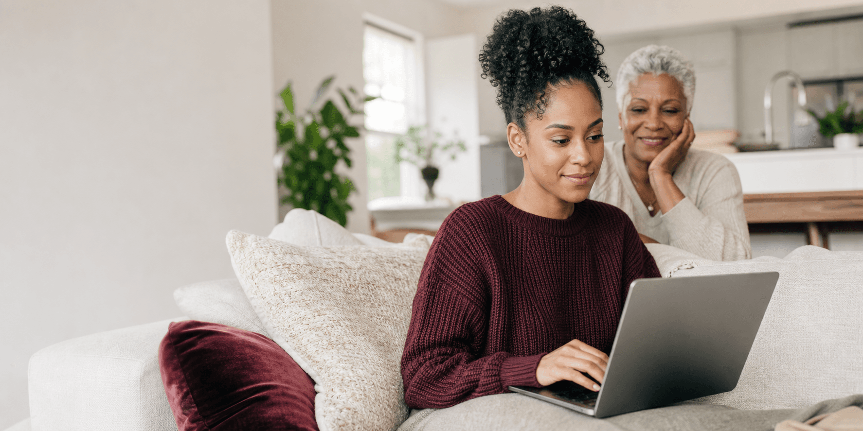 A woman and an older family member using a laptop together to find care